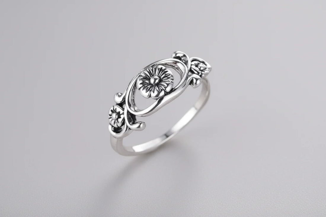 Silver retro floral hollow flower ring on display