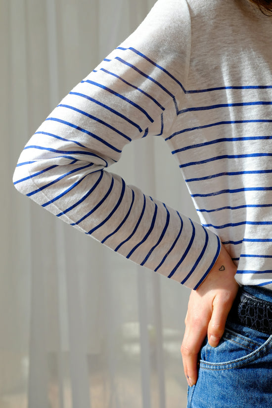 person in white and gray striped long sleeve shirt