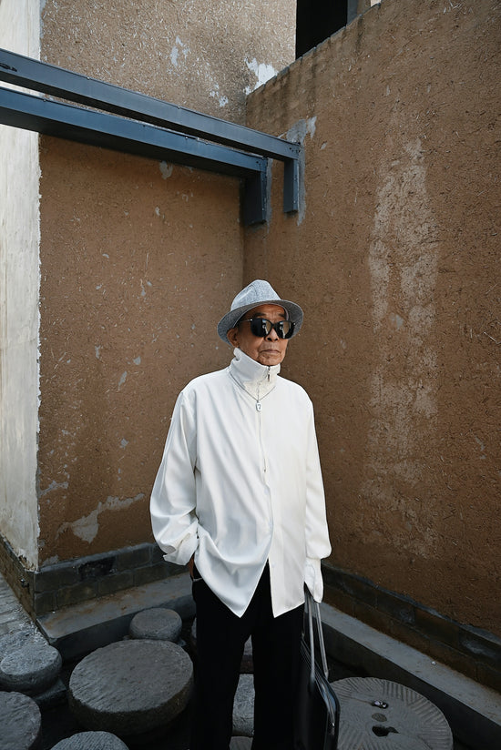 a man wearing a hat and sunglasses