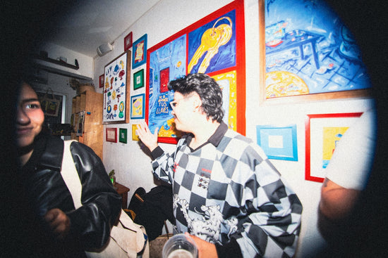 People in a room with colorful art on walls