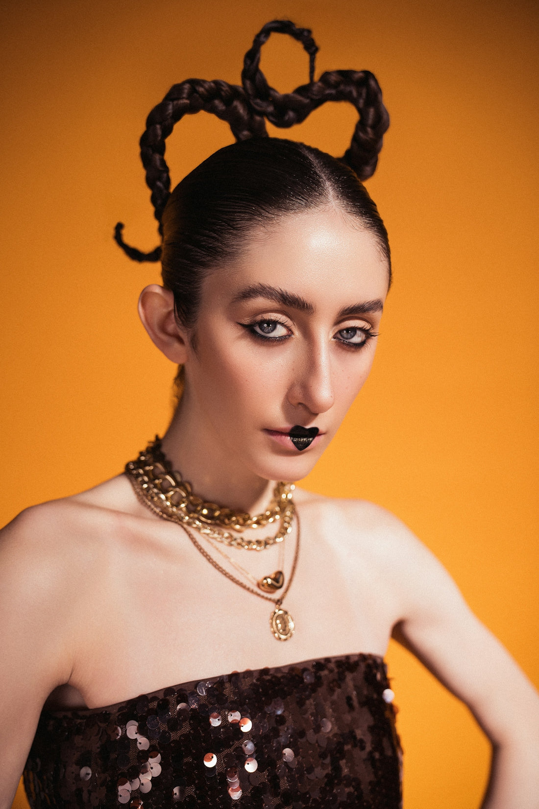 A woman with bold makeup and a unique hairstyle.