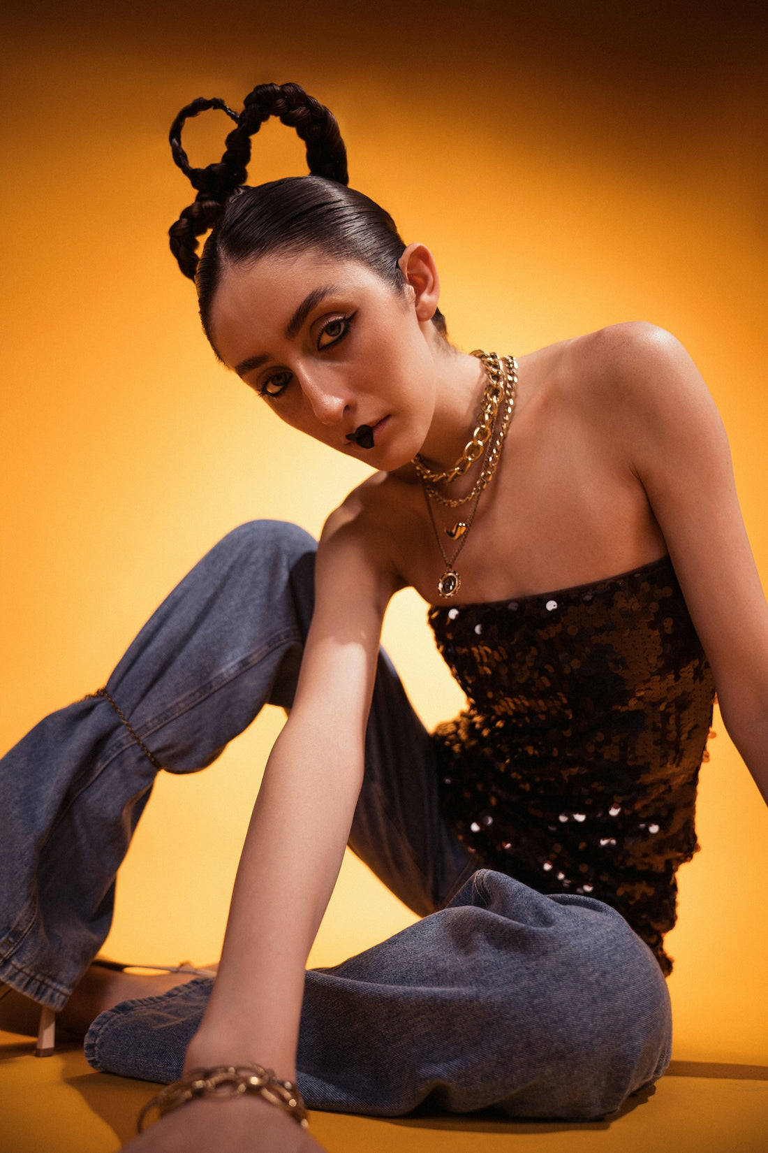 A model poses with braids and bold makeup.