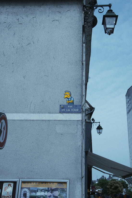 Homer simpson sticker on a street sign