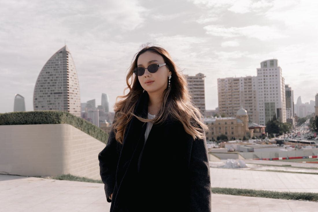 Woman in sunglasses with cityscape background