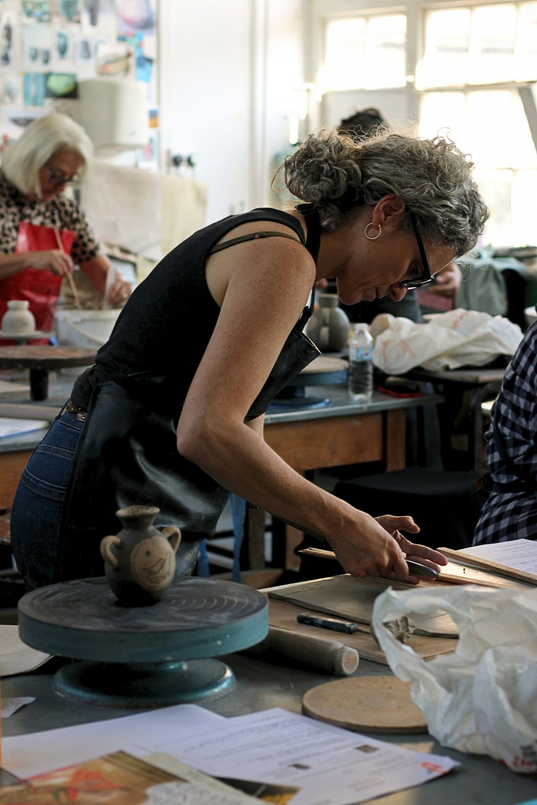 Woman working with clay in an art studio