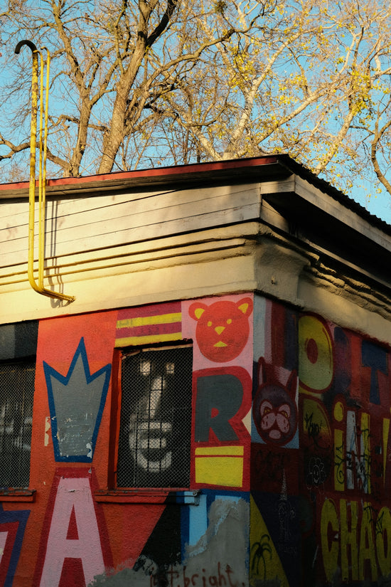 Building corner covered in colorful graffiti art