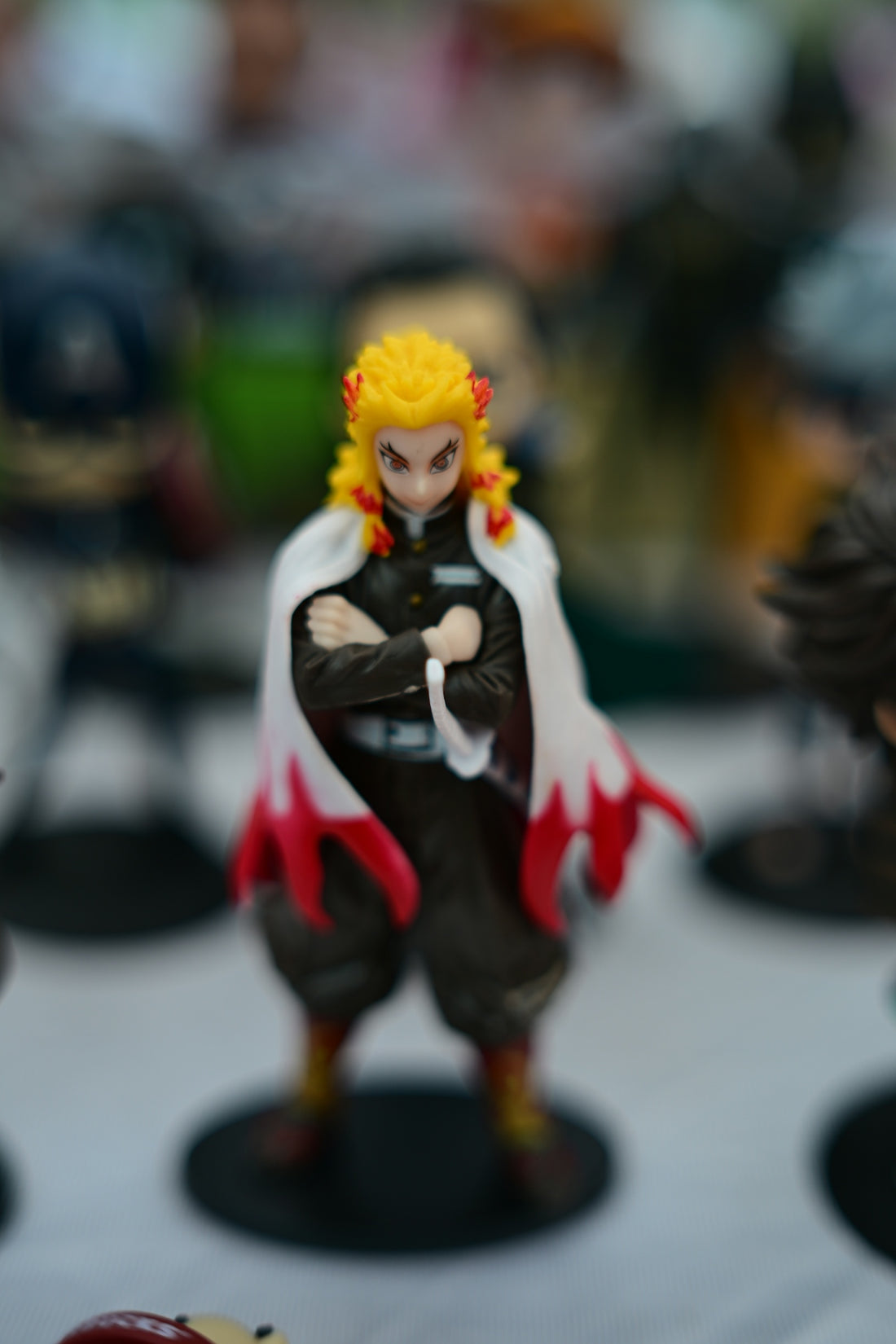 Anime figure with yellow hair and white cape