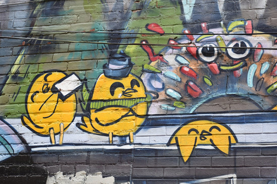 Graffiti art featuring cartoon yellow birds and a monster.