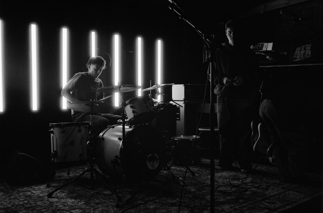 Musicians performing on a stage with bright lights