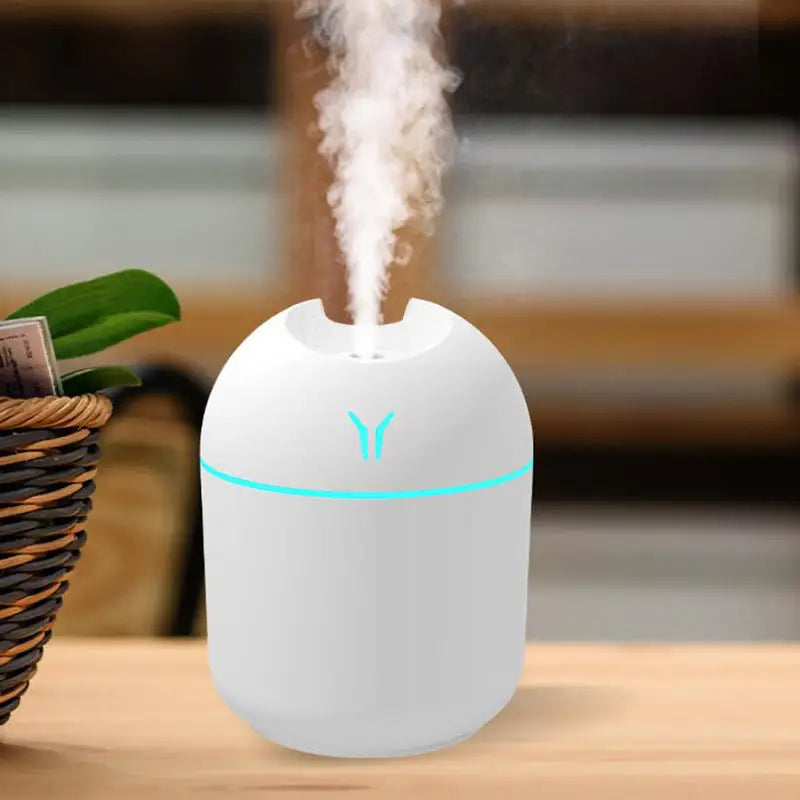 250ML USB Mini Air Humidifier with LED color lamp producing aromatic mist in home setting.