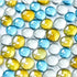 Close-up of small round glass beads in blue, yellow, and clear colors on a white surface