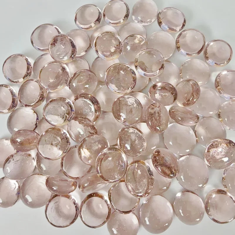 Smooth polished round rose quartz gemstones on a light background, semi-transparent pink crystals