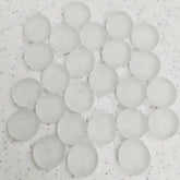 Cluster of translucent white silica gel desiccant beads on speckled surface