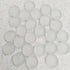 Cluster of translucent white silica gel desiccant beads on speckled surface