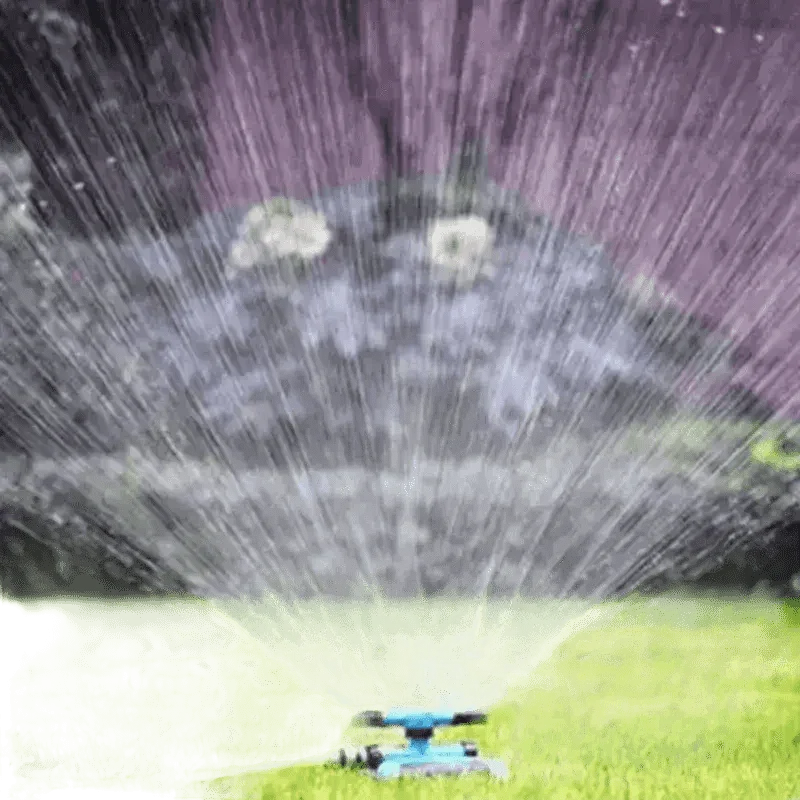 Blue Rotating Garden Sprinklers Watering Grass - GiFTiFY