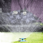 Blue Rotating Garden Sprinklers Watering Grass - GiFTiFY