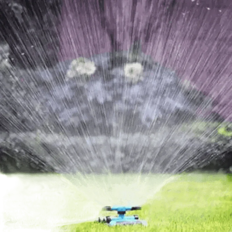 Blue Rotating Garden Sprinklers Watering Grass - GiFTiFY