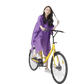 Woman in Colorful Waterproof Long Raincoat on Yellow Bicycle - GiFTiFY