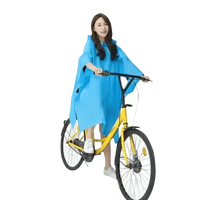 Woman in Colorful Waterproof Long Raincoat on Yellow Bicycle