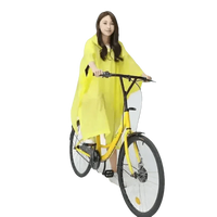 Woman in Colorful Waterproof Long Raincoat on Yellow Bicycle