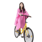 Woman in Colorful Waterproof Long Raincoat on Yellow Bicycle - GiFTiFY