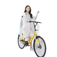 Woman in Colorful Waterproof Long Raincoat on Yellow Bicycle
